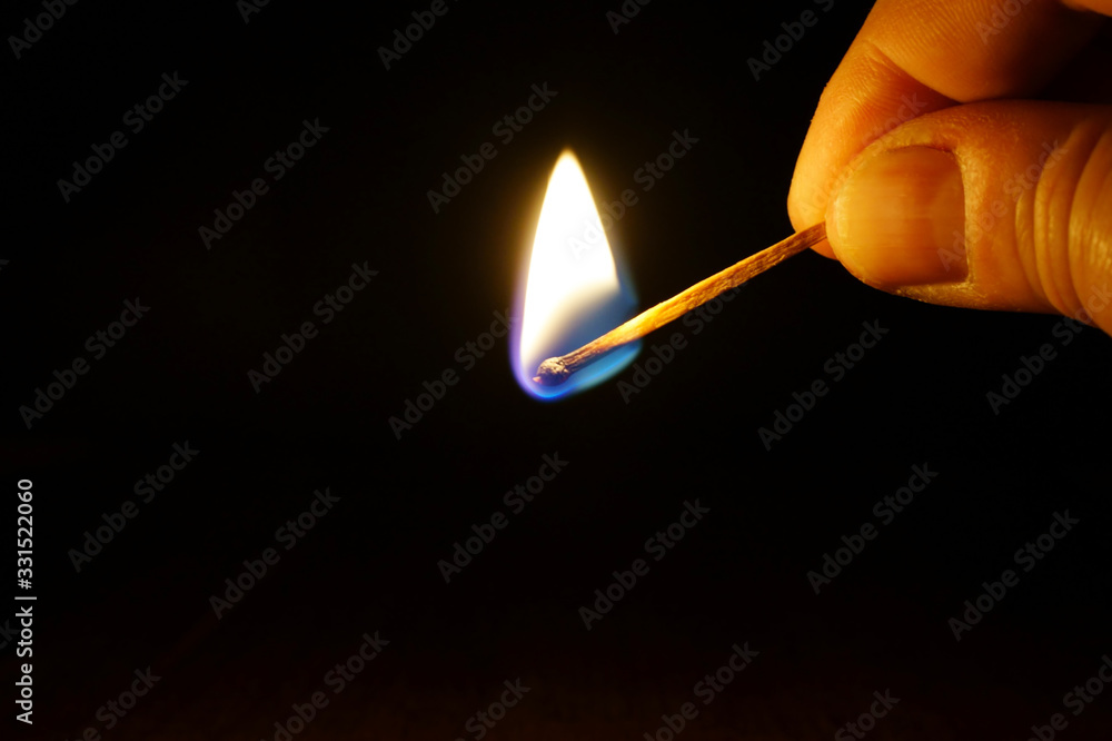 Burning match in a hand