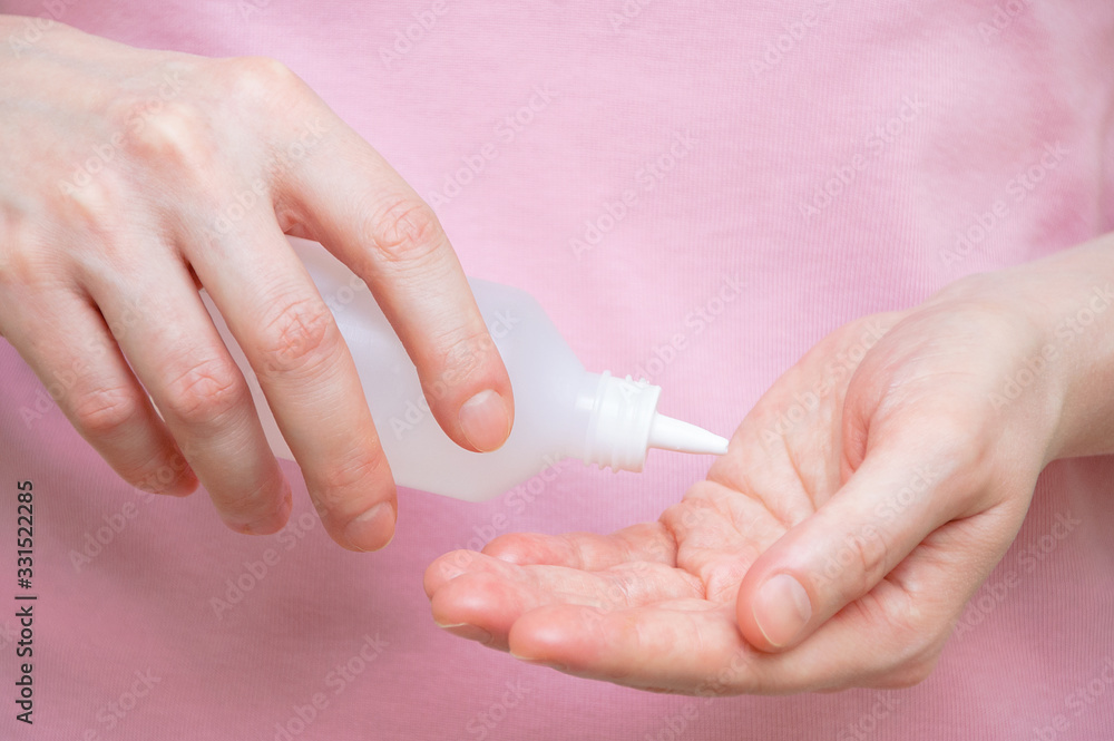 Sanitizer antibacterial in the hands of a Caucasian woman. Hand treatment for bacteria and viruses. Sanitizer antibacterial in the hands of a Caucasian woman. Hand treatment for bacteria and viruses.