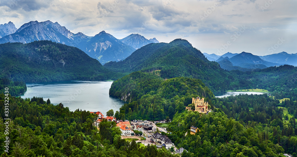 Hoehenschwangau castle with Alpsee left and Schwansee right and Alps in the background.