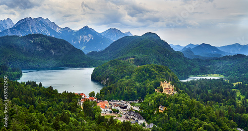 Hoehenschwangau castle with Alpsee left and Schwansee right and Alps in the background.