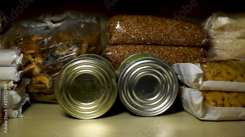 Stocks of cereals, sugar, pasta and canned goods on pantry shelf