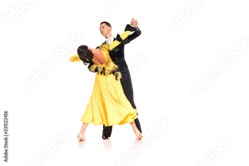 elegant young couple of ballroom dancers dancing isolated on white