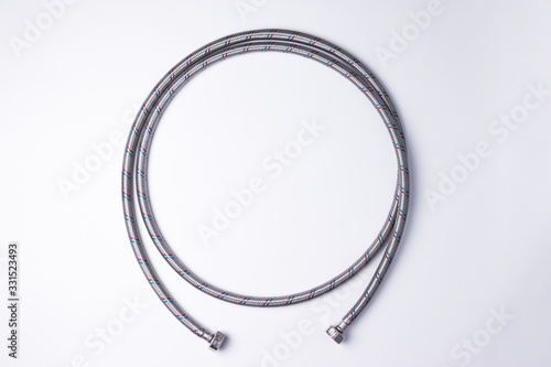 Flexible hose is reinforced with a metal braided. Water fittings for connecting hot or cold water. photo