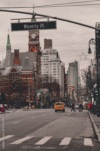 New York City streets of Manhattan. Big city life in New York State. Manhattan streets full of people and yellow taxi. Busy district streets. Skyscrapper buildings. Historical buildings.