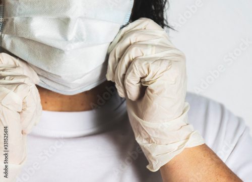 Woman in medical face protection mask and medical gloves