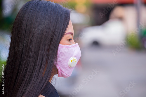 Asian women wearing mask prevent, protection  Coronavirus, Covit-19 in the city blackground . photo