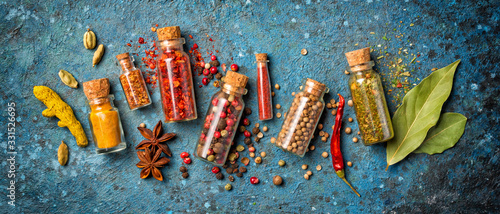 Fototapeta Naklejka Na Ścianę i Meble -  Different spices in glass vials for tasty meals