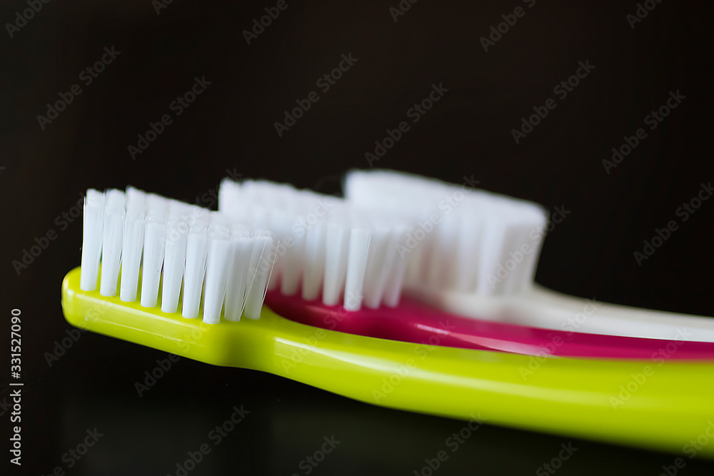 Bright toothbrushes close-up on a black background. Bright toothbrushes close-up on a black background.