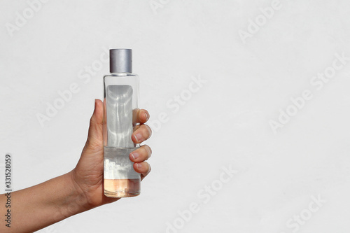 Hand with cologne isolated on white background