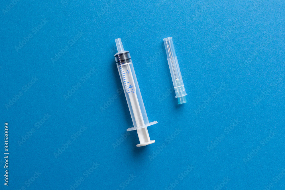 Syringe and needle on a blue background. Syringe and needle on a blue background.