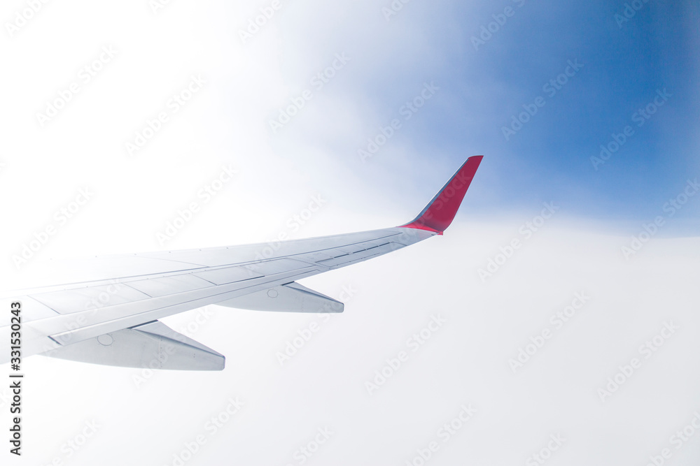 Obraz premium Empty airplane wing view via passenger window with blue sky, clean and modern look