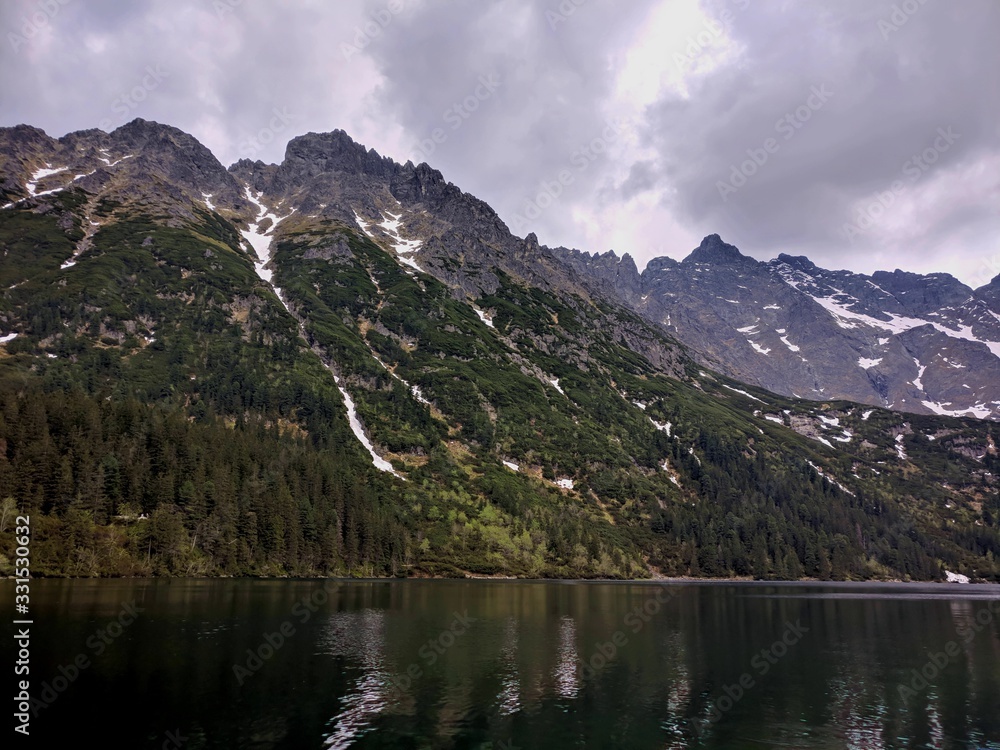 Image of Morskie Oko Lake and mountains nearby on a cloudy day