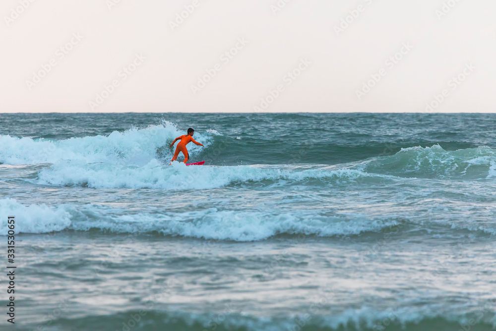Surfer rides the waves of the Mediterranean Sea