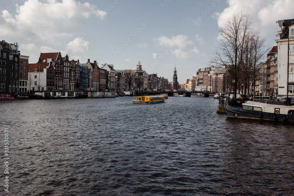 panoramic view of the amstel river in the city of Amsterdan with blue cloud sky