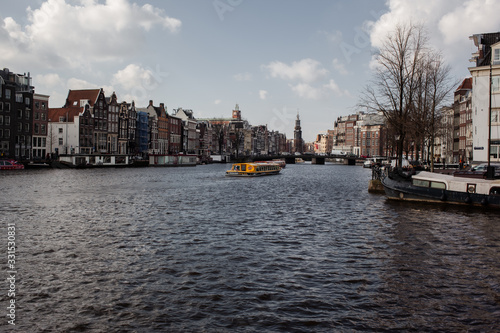 panoramic view of the amstel river in the city of Amsterdan with blue cloud sky