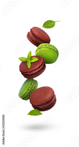 Chocolate macaroons isolated on a white background, fresh mint leaves fly, mint macaroons, green cookies