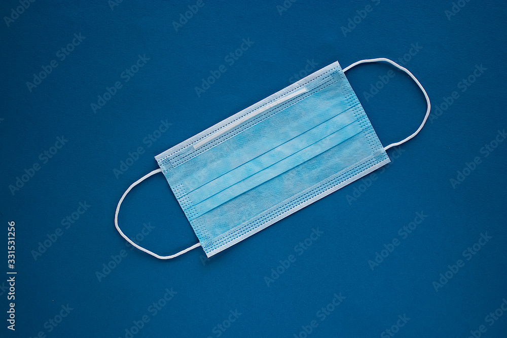 Blue medical masks on a blue background. Сoronavirus. Healthcare and medical concept. Blue medical masks on a blue background. Сoronavirus. Healthcare and medical concept.