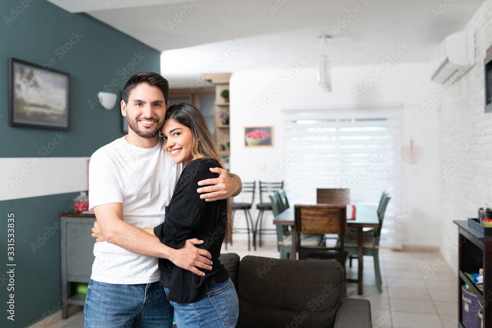 Happy Latin Couple Embracing At Home Happy Latin Couple Embracing At Home