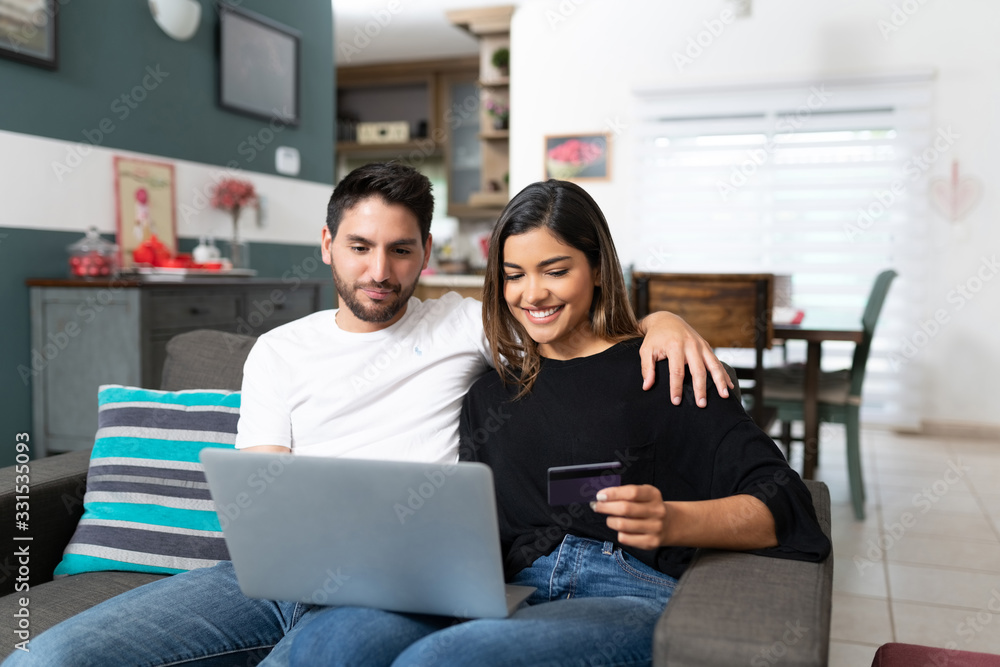 Smiling Couple Doing Online Shopping At Home Smiling Couple Doing Online Shopping At Home