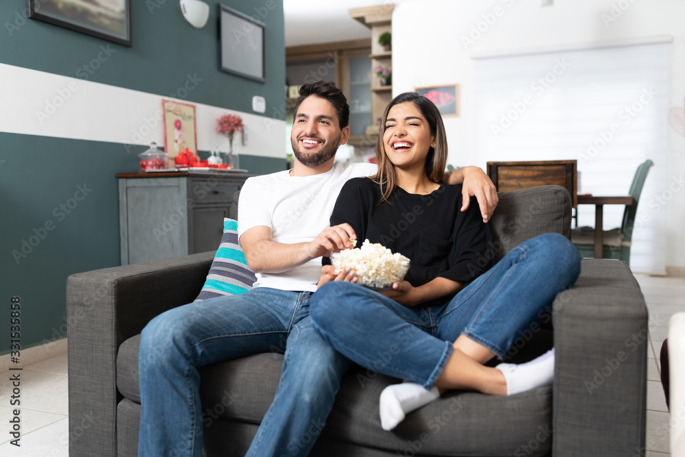 Latin Couple Watching Movie At Home