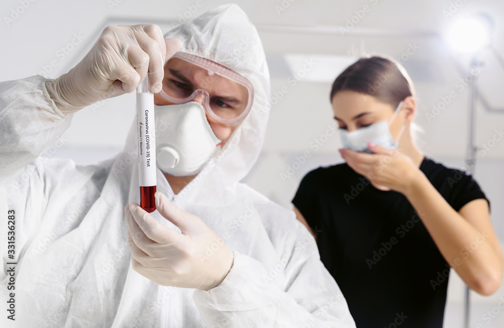 Pandemic covid-19. A virologist doctor holding a patient’s blood sample in test tube. An infected girl coughs in the background. Disease vaccine development Pandemic covid-19. A virologist doctor holding a patient’s blood sample in test tube. An infected girl coughs in the background. Disease vaccine development