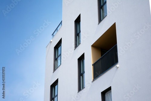 Exterior of new apartment buildings on a blue cloudy sky background. No people. Real estate business concept.