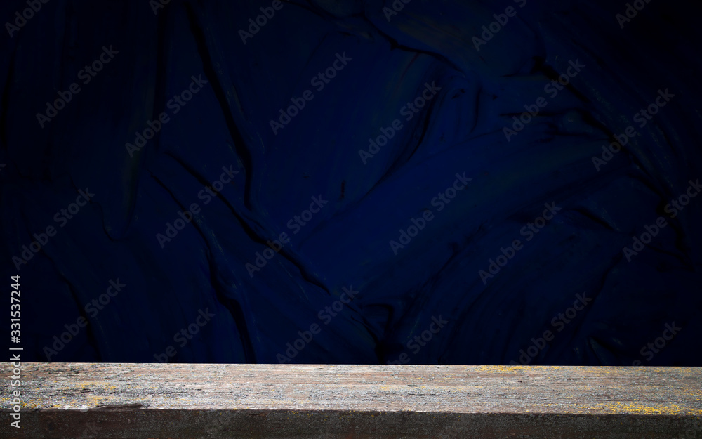 Obraz premium Empty, free, wooden table in front of an abstract dark wall background. Can be used to display or edit your products.