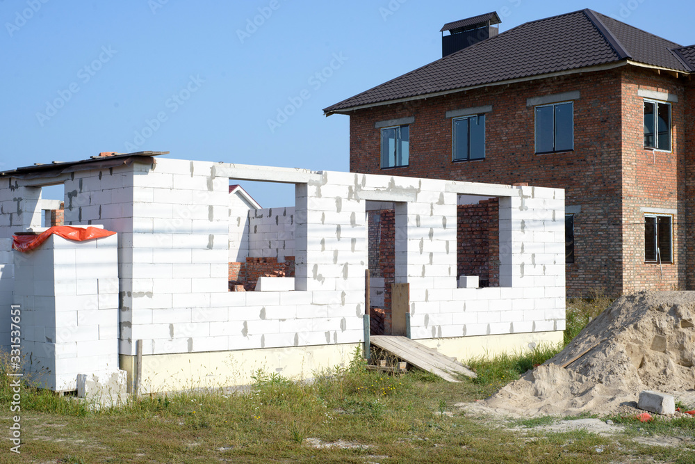 Home under construction on a building site Home under construction on a building site
