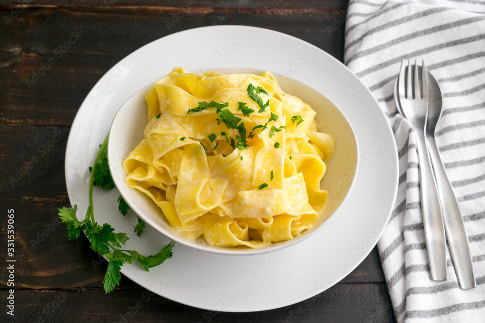 Pappardelle al Limone (Creamy Lemon Pasta): A bowl of wide noodles in a creamy lemon-parmesan sauce