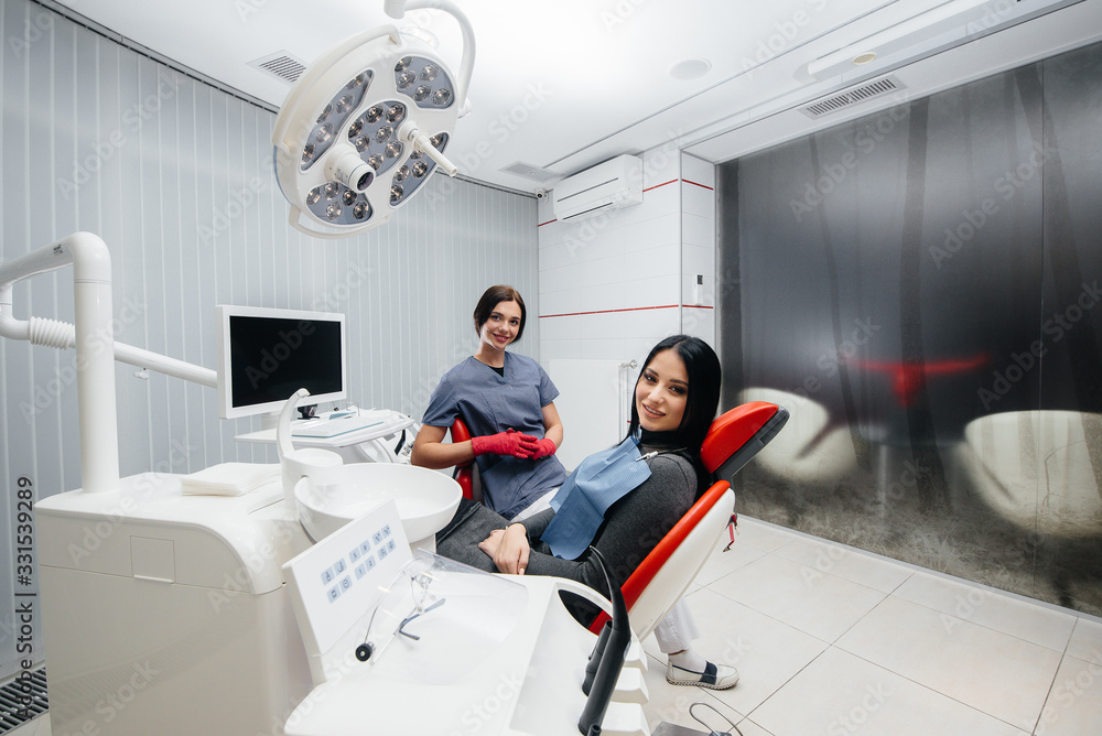 Doctor and patient look at the camera, smile health. Dentistry