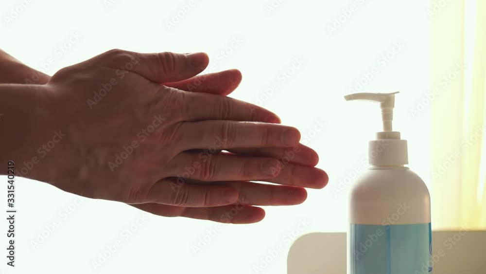 A man makes hand disinfection an antiseptic. Alcohol-based sanitizer extracted on a man's fingers hand. Reduce the risk of getting and spreading infection like coronavirus COVID-19. Hands hygiene. A man makes hand disinfection an antiseptic. Alcohol-based sanitizer extracted on a man's fingers hand. Reduce the risk of getting and spreading infection like coronavirus COVID-19. Hands hygiene.