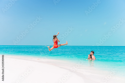 Little girl and happy dad having fun during beach vacation © travnikovstudio