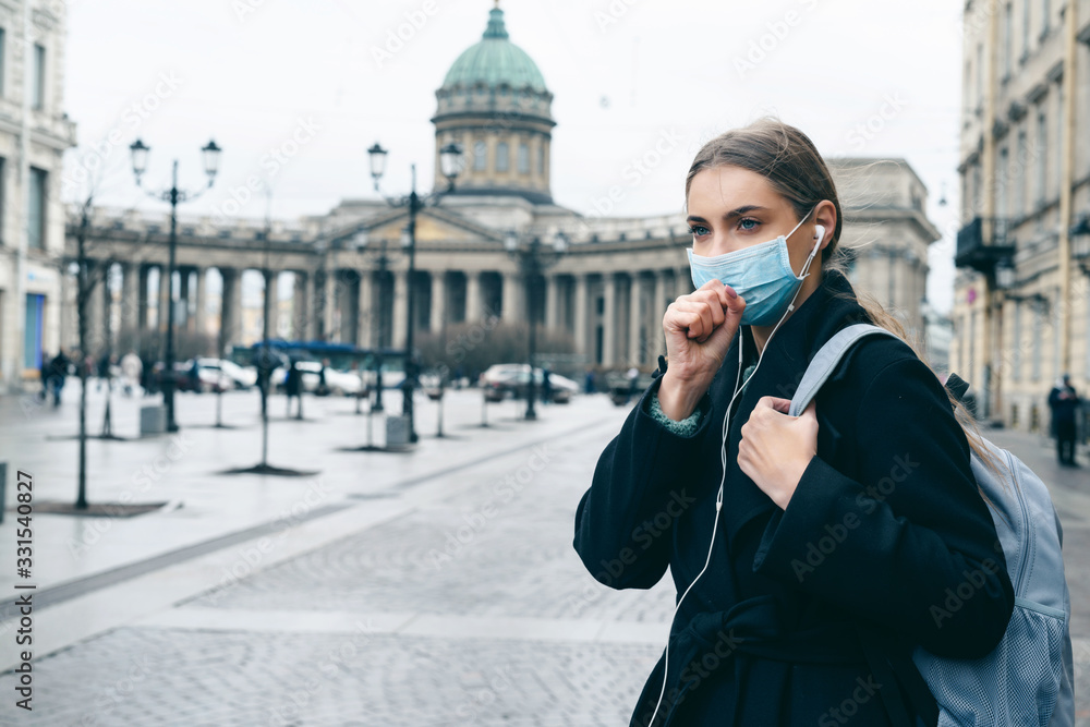 Quarantine in europe in 2020. Prevention of coronavirus outbreak. Portrait of young european woman wearing a mask in the city street. Prevent pollution and disease concept. Quarantine in europe in 2020. Prevention of coronavirus outbreak. Portrait of young european woman wearing a mask in the city street. Prevent pollution and disease concept.