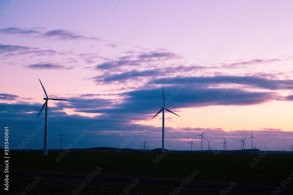 wind generators in the counter sky at sunset wind generators in the counter sky at sunset
