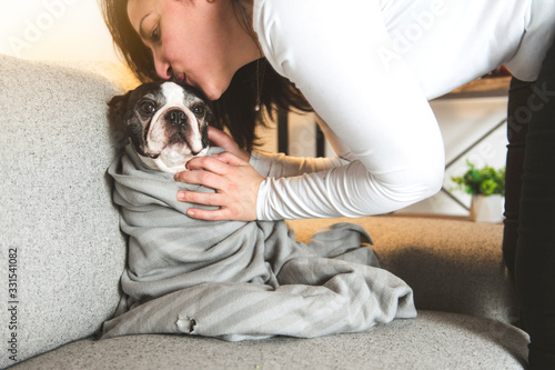 Woman with is Boston Terrier on the living room