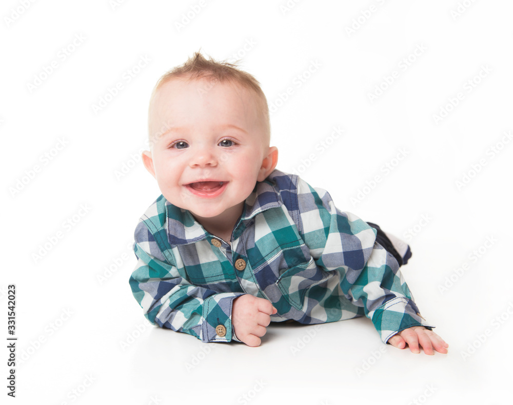 Baby boy sitting on the floor, calm and relaxed Baby boy sitting on the floor, calm and relaxed
