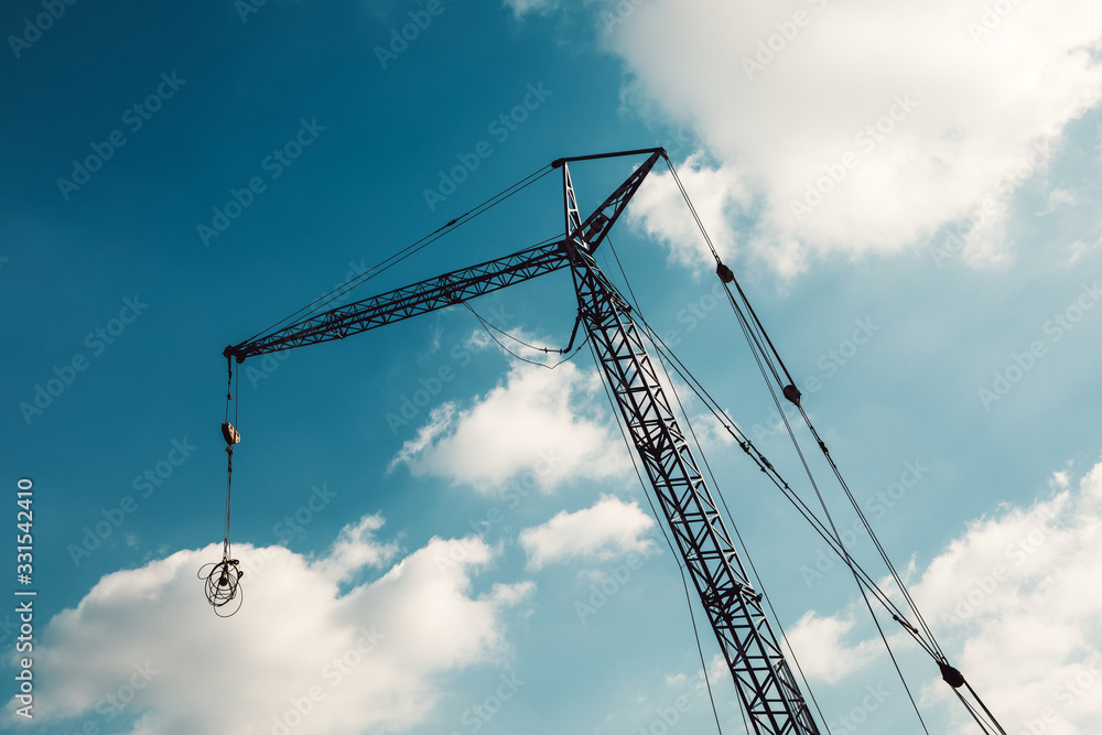 construction site with cranes on blue sky background