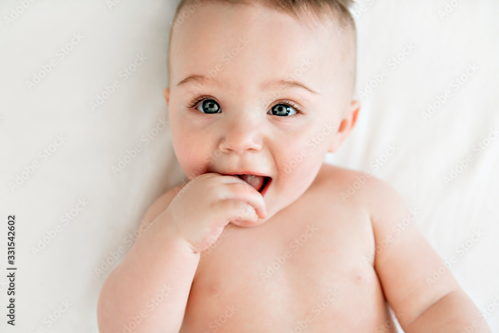 cute baby boy lying on a white bed cute baby boy lying on a white bed