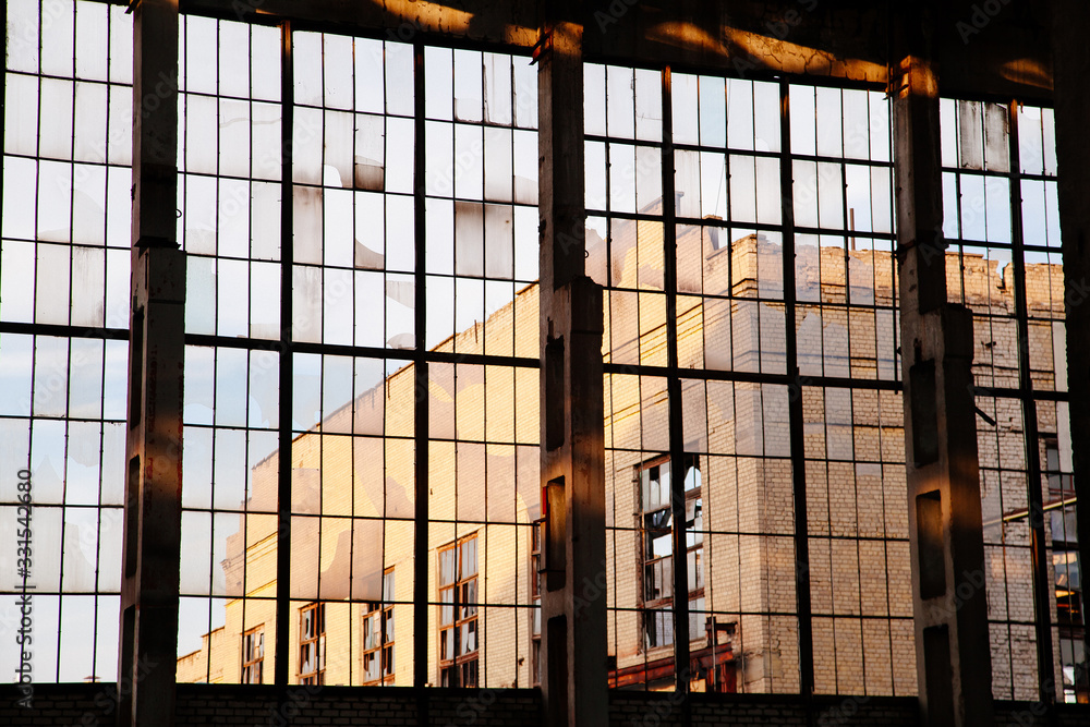 Old broken glass windows at abandoned factory