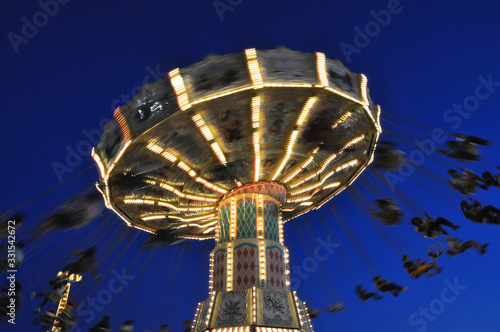 Photography Long exposure of a colorful ferris wheel at night..