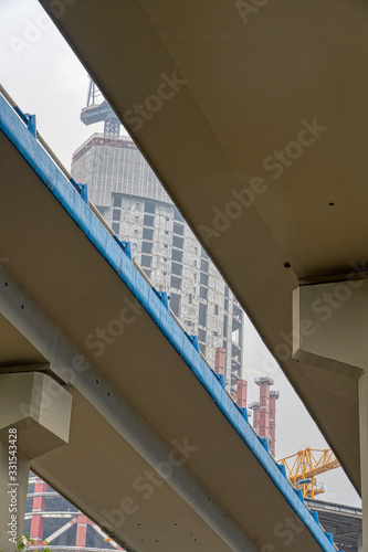 Chongqing, China - Dec 20, 2019: Skyscraper in construction view from under flyover