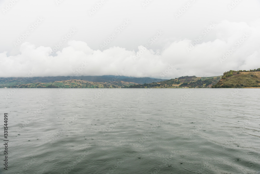 Rain drops fall on the surface of the water in the largest lake in Colombia