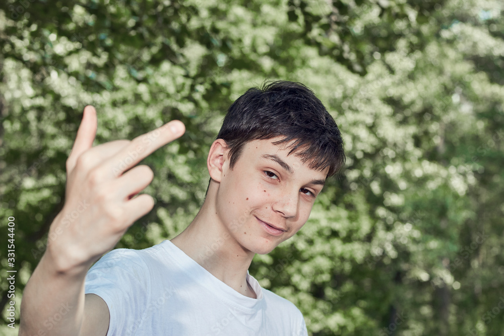 teenager showing thumbs up on background of nature teenager showing thumbs up on background of nature