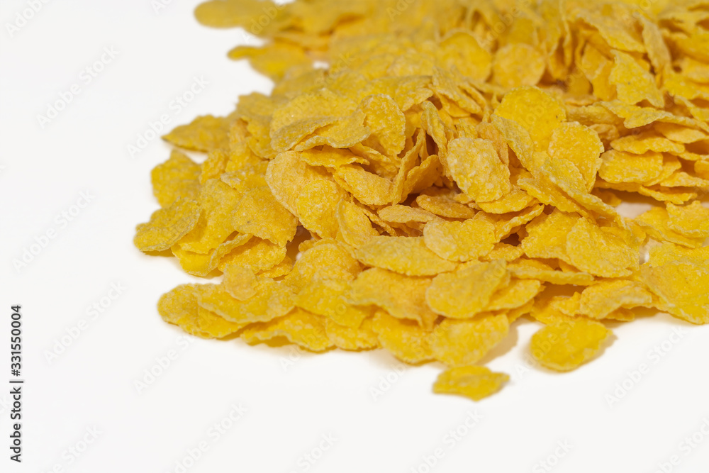 Corn flakes on a white background close-up Corn flakes on a white background close-up