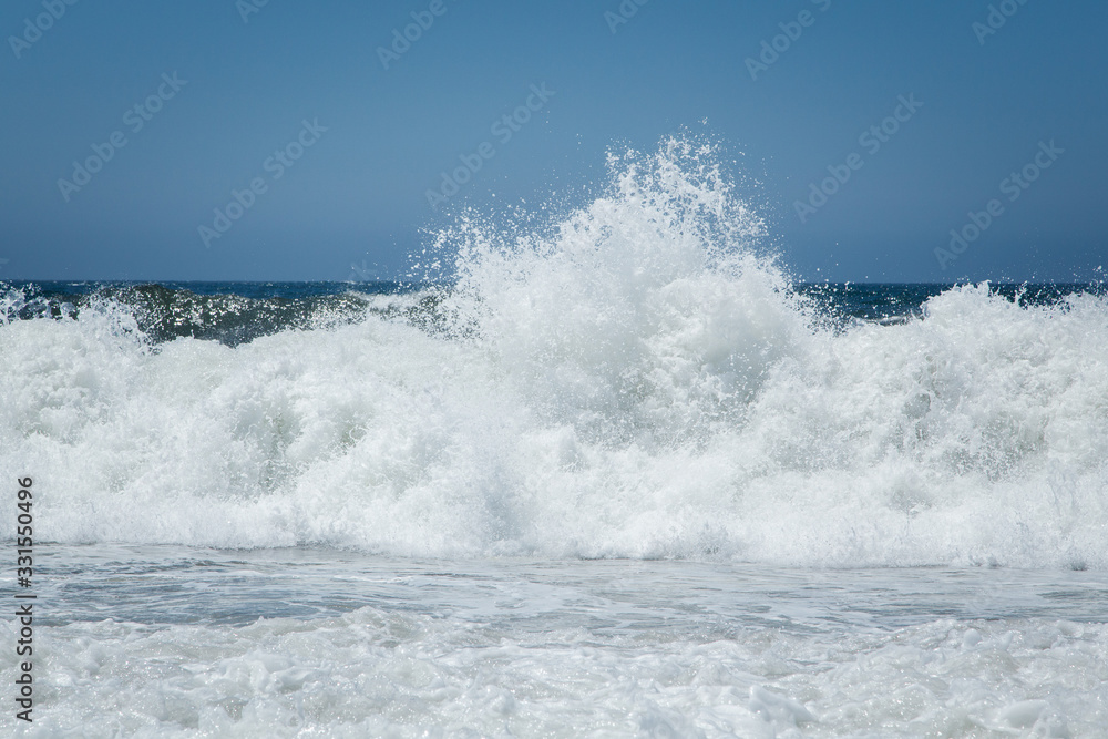 Wave Spray at Beach Coastline