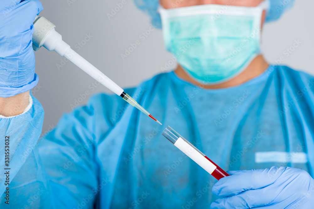 The uniformed doctor takes a blood sample for a coronavirus test. The uniformed doctor takes a blood sample for a coronavirus test.