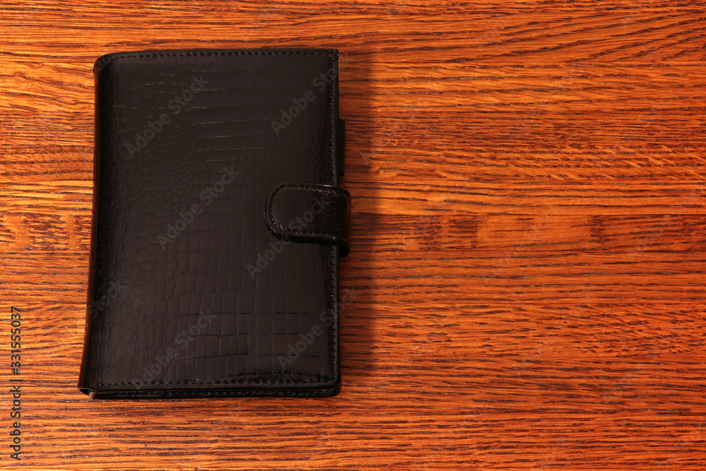 A record book, note book on a wooden background.
