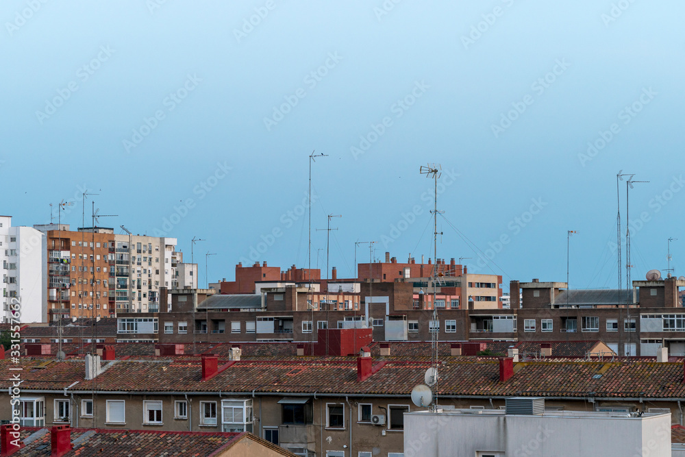 Satellite antenna and old roof antenna on red house roofs Satellite antenna and old roof antenna on red house roofs