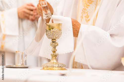 Priest' hands during a wedding ceremony/nuptial mass (shallow DOF; color toned image) photo