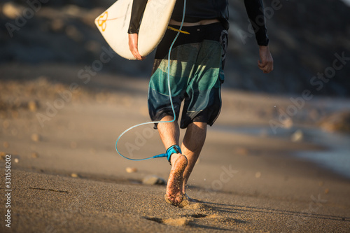 Young boy surfing the wave in a sunny day